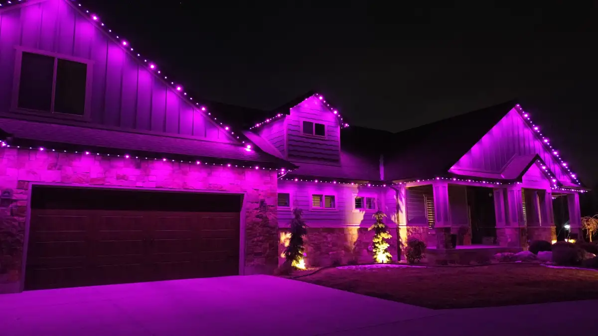 Holiday lighting on a home at dusk